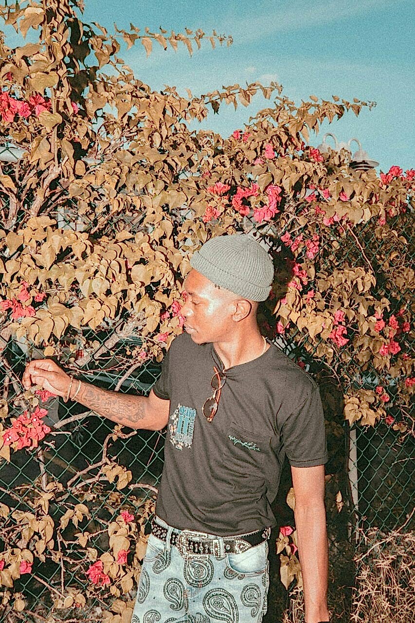 Man standing in front of a fall tree