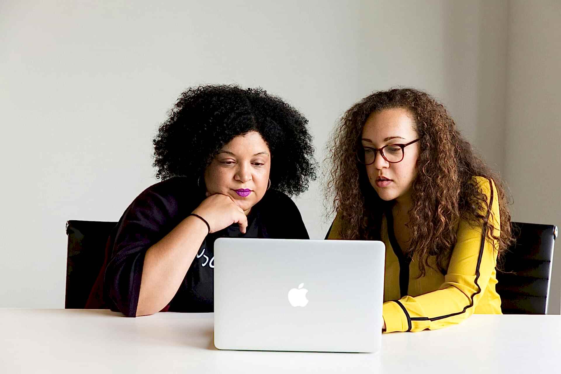 Two women looking at a laptop together