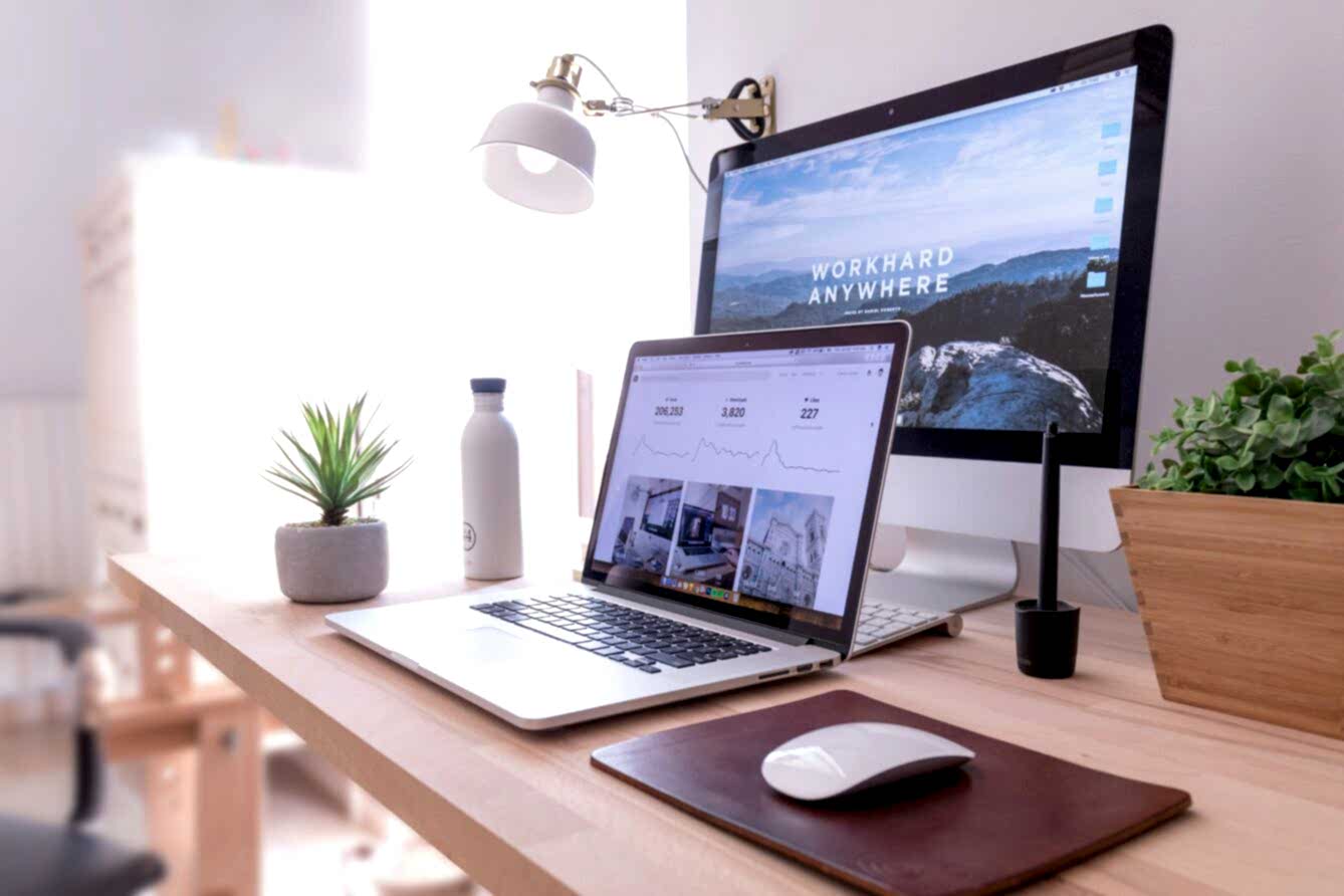 Desk showing a desktop computer and a laptop