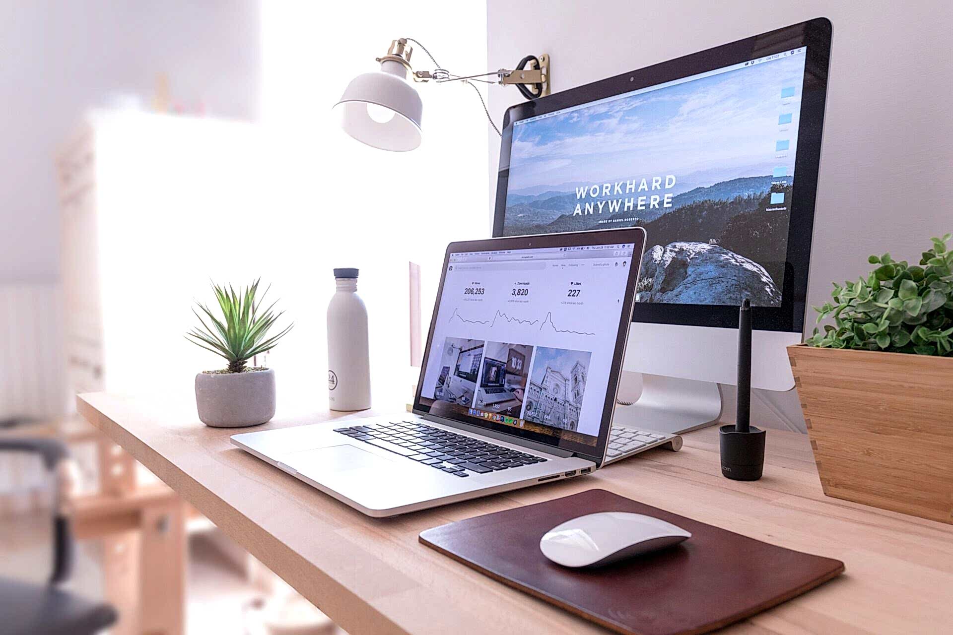 Desk showing a desktop computer and a laptop