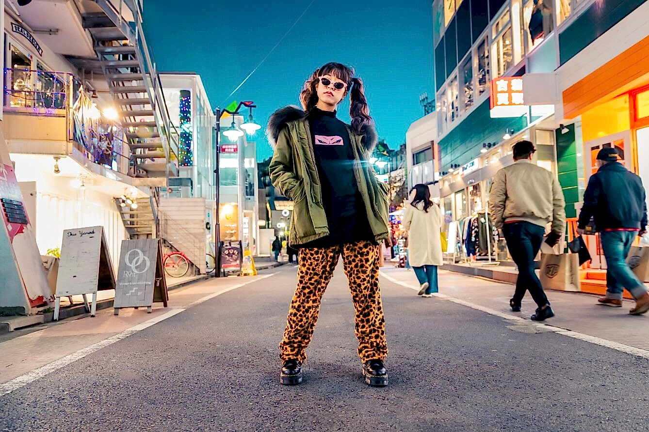 A woman standing in the middle of a city street