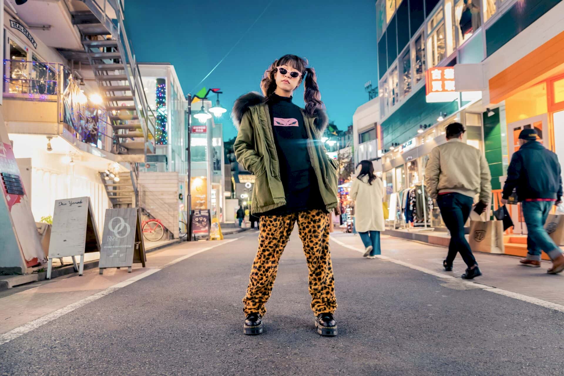 A woman standing in the middle of a city street