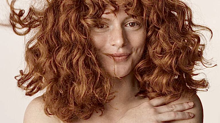 Close-up of woman with curly, red hair