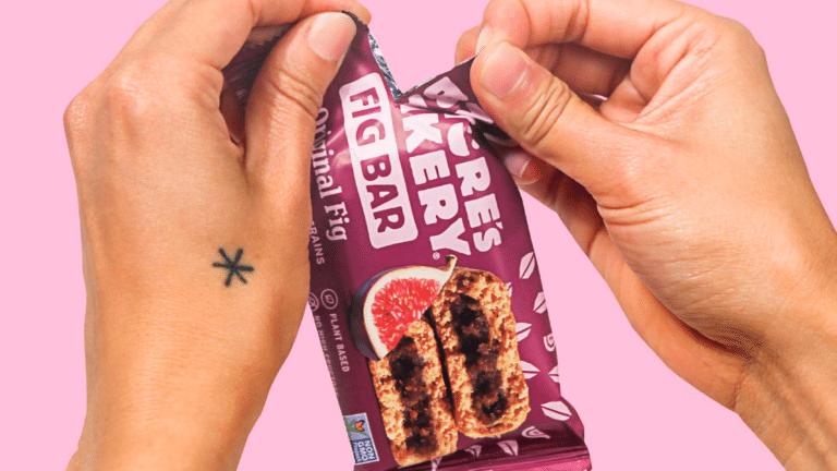 A person opening a package of Nature's Bakery fig bar