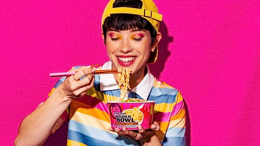 Person smiling while eating a ginormous bowl of Maruchan ramen